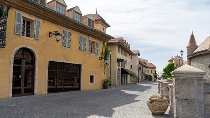 Walking area with shops and restaurants in United Arab Emirates. Riverland, Dubai. Houses in style of medieval Europe