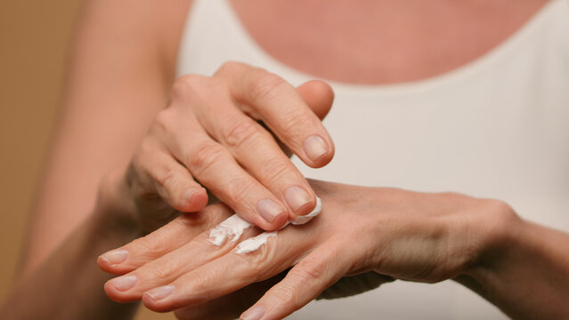 Close up female wrinkled hands mature old woman applying moisturizing cream natural beauty anti-aging skincare cosmetics lifting body lotion soft moisturize daily treatment dry skin palms cosmetology