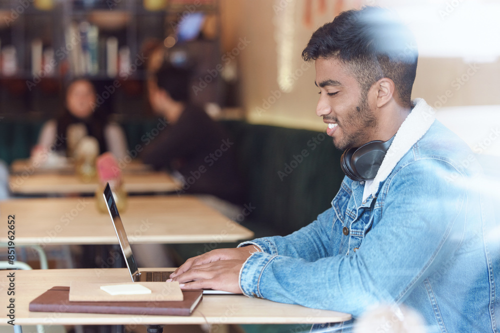 Poster man, happy and cafe or typing on laptop for remote work, freelancer and report or searching on inter