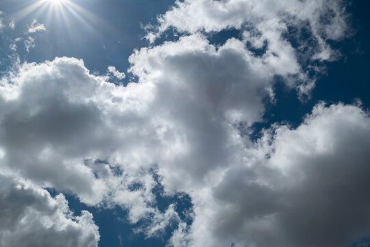C&eacute;u com nuvens tempestuosas com o sol &agrave; espreita em meio aos clar&otilde;es ensolarados
