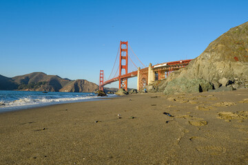 View on golden gate bridge from a beach at sunset