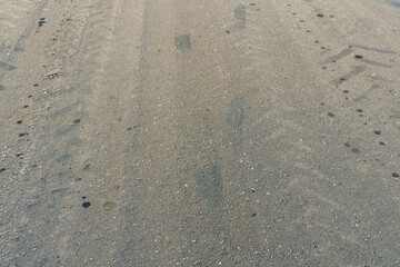 Empty asphalt road, close-up. Car tracks on the asphalt.