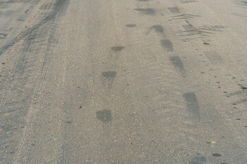 Empty asphalt road, close-up. Car tracks on the asphalt.