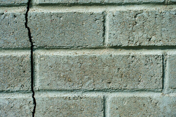 paving slabs close-up. A crack in the wall of the building.