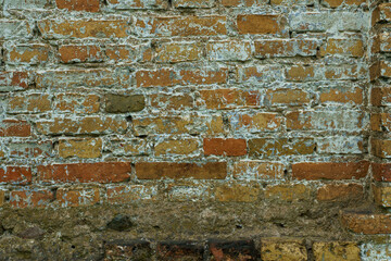 The surface is made of old red brick. A wall of old historical buildings made of broken bricks and collapsed plaster. A clean background for the design.