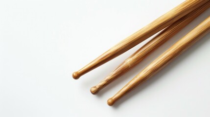 Close up shot of drumsticks on a crisp white background with ample space for text