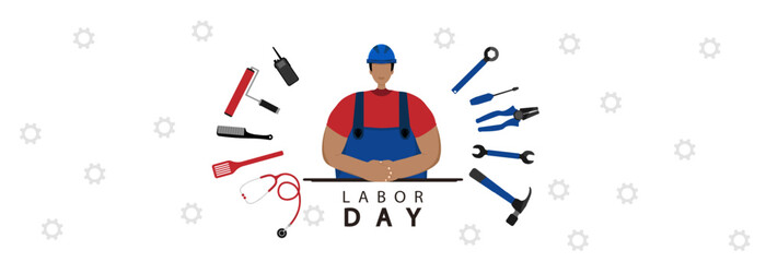 A worker in a construction helmet and various tools of various professions. Happy labor day.