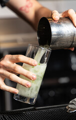 Bartender Pouring Cocktail from Shaker