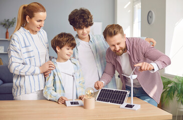 Family with children is learning solar panels, studying the technology of solar energy power and its ecological benefits. Curiosity and interest in sustainable, photovoltaic energy solutions for home.