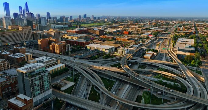Approaching the complex interchange with lively traffic in Chicago, Illinois, US. Sunset view of the city from top.