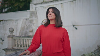 Gorgeous woman strolling city landmark at evening closeup. Model looking camera