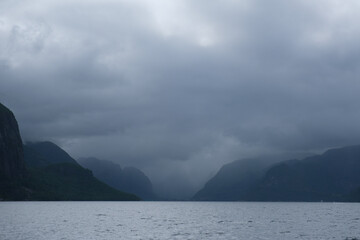 clouds over fjord, mountains and lake