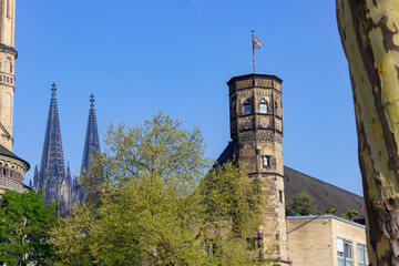 Historic Town Hall with Cologne Cathedral in the background, viewed from the river Rhine promenade in Cologne, Germany