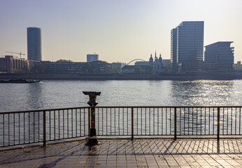 Rhine River skyline with viewing binoculars and the district of Deutz in Cologne, Germany