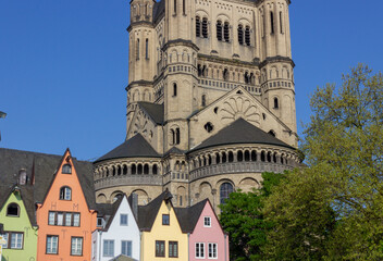 Colorful houses and Groß St. Martin Church (Groß St. Martin) viewed from the Rhine promenade in Cologne, Germany