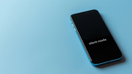 Smartphone with black screen in silent mode, on blue background