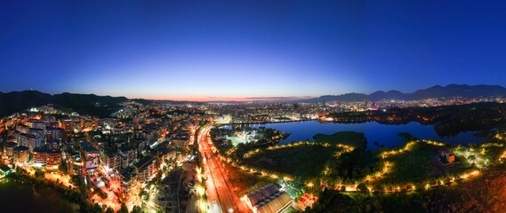 Panoramic aerial image of the city of Tirana from the outer ring road showing the artificial lake...