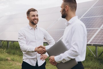 Two Electrical Engineers shaking hands after working to inspect the installation and maintenance of...