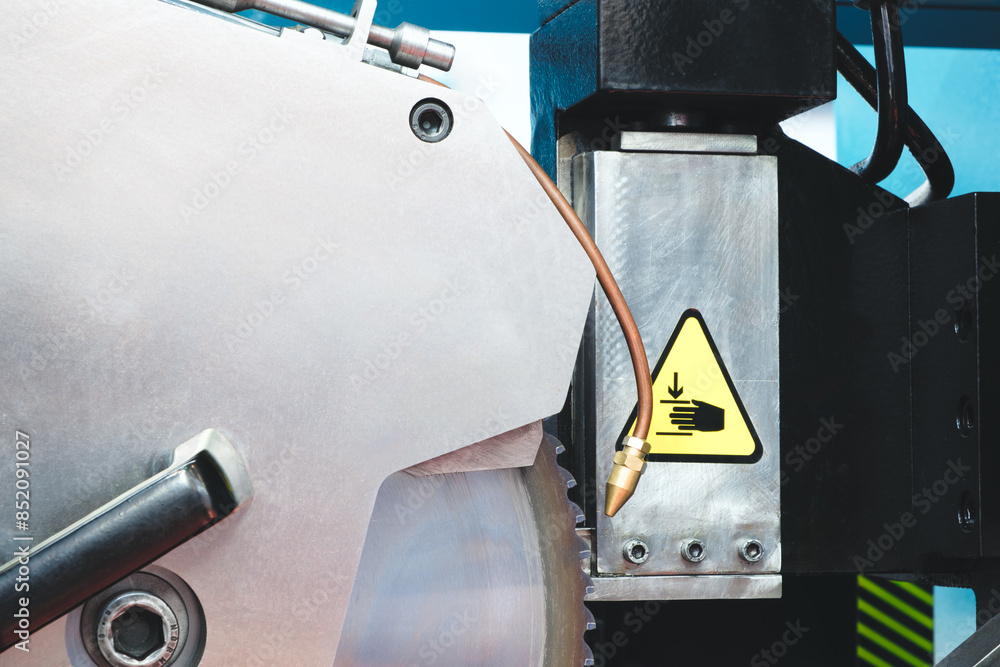 Poster a close up of a machine with a large circular blade