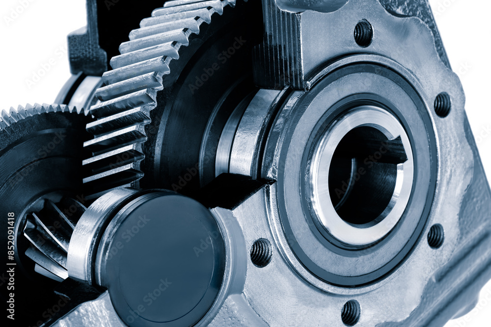 Poster A close up of a gear with a black cap on it. The gear is part of a larger machine