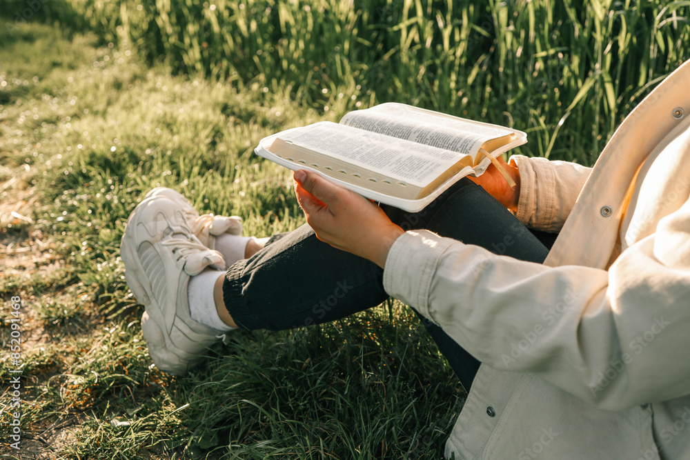 Wall mural open bible in hands close-up, concept of calmness and morning solitude