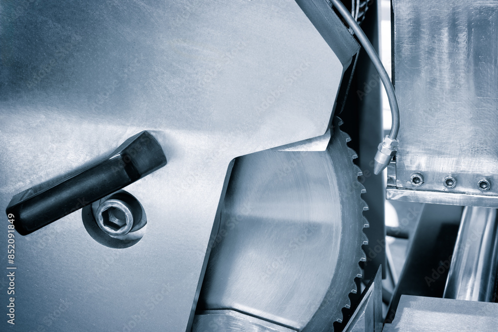 Poster A close up of a machine with a large circular blade
