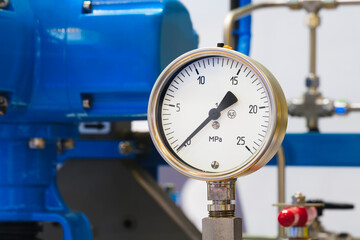 Industrial  concept. equipment of the boiler-house, - valves, tubes, pressure gauges, thermometer. Close up of manometer, pipe, flow meter, water pumps and valves of heating system in a boiler room.