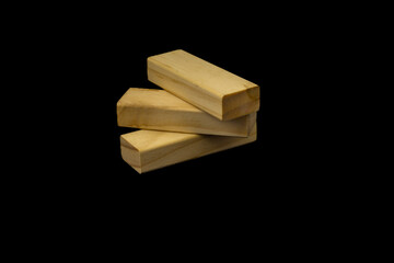 Wooden blocks for the game Jenga on a black background