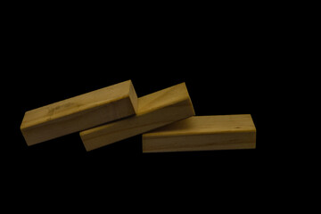 Wooden blocks for the game Jenga on a black background