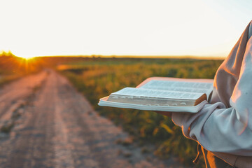Open bible in hands close-up, concept of calmness and morning solitude