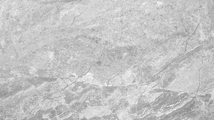 A gray stone wall with a few cracks. The wall is very smooth and has a very clean look