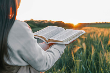 Open bible in hands close-up, concept of calmness and morning solitude