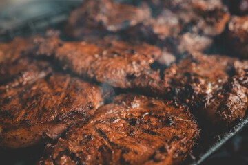 Man hand grilling barbecue with smoked pork at backyard on day. Family dinner outdoor style bbq activity