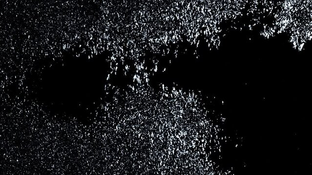 Snow and sleet falling on a window at Christmas time with rain drops. Cold wet weather on window pane