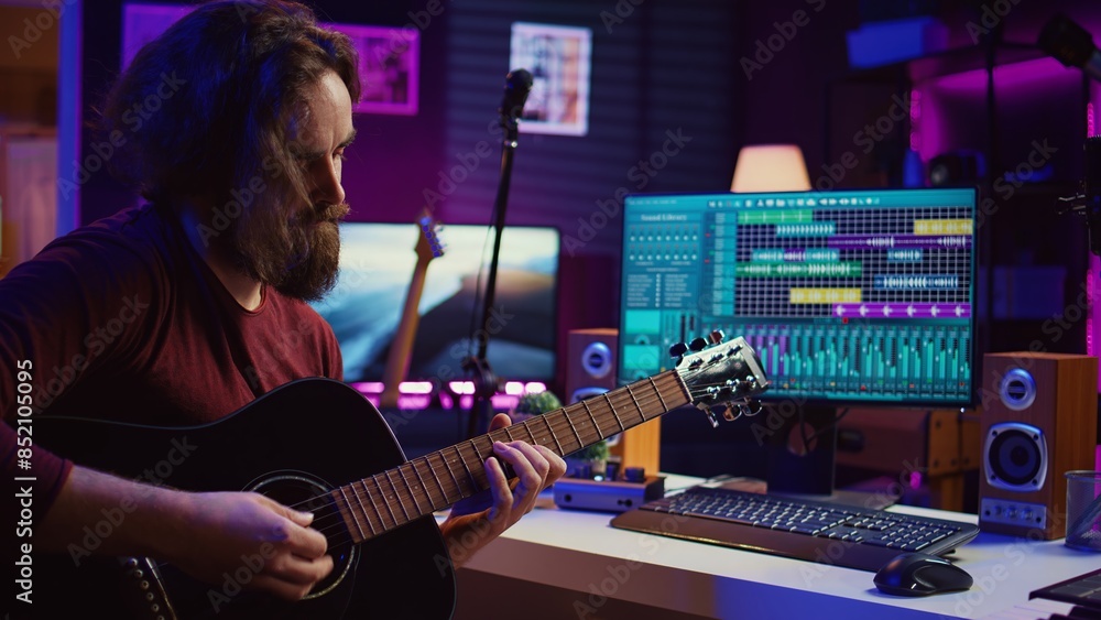 Aufkleber Artist playing guitar and uses DAW software interface to create music, looking at mastering controls on computer screen. Musician recording soundtracks with tools, acoustical engineering. Camera B.