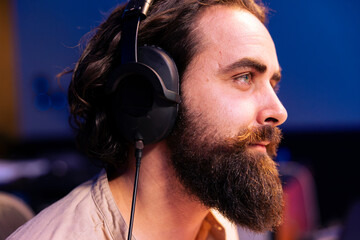 Sound designer working on a new track for pop rock album in studio, recording and processing music...