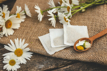 A bag of chamomile tea. Herbal chamomile tea in a bag on wooden background