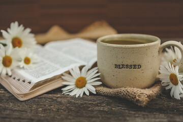 Cup with the inscription blessed and open Bible, Christian concept