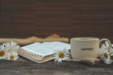 Cup with the inscription blessed and open Bible, Christian concept