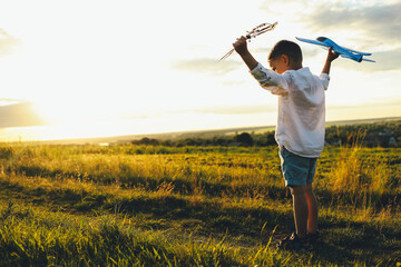 Child on a field at sunset, happy childhood