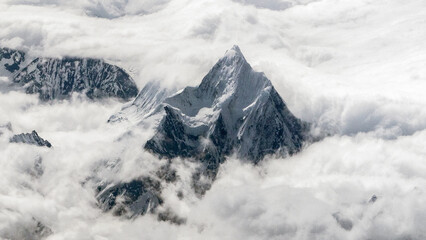 Obraz premium The 7756m peak of the Namcha Barwa Himal range, Pemako, Tibet. One of the highest mountains in the world, this is the third most prominent peak in the Himalayas after Mount Everest and Nanga Parbat.