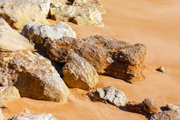 Sandy beach with rocks. Coast with big stones