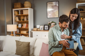 Fototapeta premium Boyfriend read a book while girlfriend hug him love, happiness