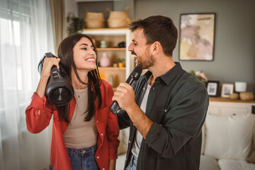 man hold microphone and sing, woman hold loudspeaker karaoke party