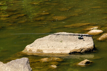 Fishing pole on the rocks