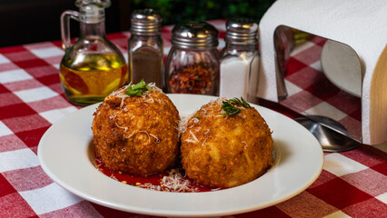 Golden Arancini with Marinara Sauce and Grated Cheese