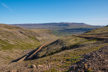 The winding gravel road leading to Raudisandur in the westfjords of Iceland