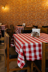 Cozy Restaurant Interior with Checkered Tablecloths and Brick Wall