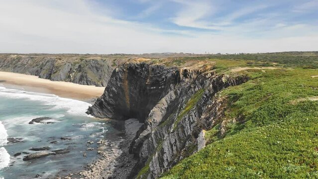 Flight above huge basalt rocks in spring. Fishermen's Trail, west of Portugal