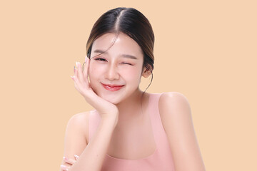 Close-up portrait of young Asian beautiful woman with K-beauty make up style and healthy and perfect skin isolated on beige background for skincare commercial product advertising.